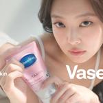 A person holds a pink tube of Vaseline Gluta‑Hya Dewy Radiance serum lotion close to the camera while looking forward, with soft lighting and a neutral background; on‑screen text reads “crystal clear skin” and “Vaseline”.