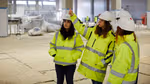A group of employees in hi-vis jackets and hard hats