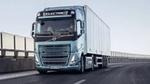 A green electric truck – one of the world’s first heavy-duty electric vehicles – being driven down a highway.