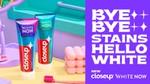 Two tubes of Closeup White Now toothpaste are displayed on a pastel-coloured surface next to a pink toothbrush. The headline reads: 'Bye Bye Stains, Hello White' in white text on a bright purple background.