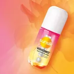 A Sunsilk Wondermist product bottle placed on a vibrant pink‑to‑orange gradient background with a soft, floral pattern.