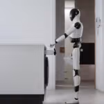 A white-and-black humanoid robot stands beside a modern washing machine in a laundry area, pouring detergent into the open detergent drawer.