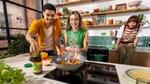 People cooking in a modern kitchen with a pan of sizzling vegetables and flames, Knorr seasoning jar visible on the counter.