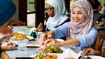 Ladies sitting at a table, eating and sharing food