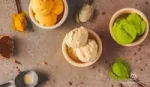 Three small bowls of ice cream on a table.