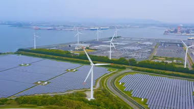 Landscape including wind turbines and solar panels