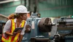 Factory worker assessing material