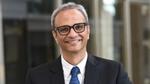 Profile picture of Srinivas Phatak wearing a white shirt, dark tie and suit jacket. He is wearing glasses.