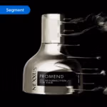 Nexxus Promend Oil Resurrection for Hair bottle in metallic silver with dynamic liquid splash effect on a black background. The image is tagged ‘Segment’.