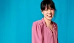 Woman in pink blouse laughing