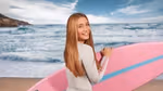 A girl holding a surf board on the beach