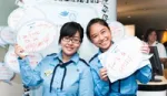 Two people holding up signs