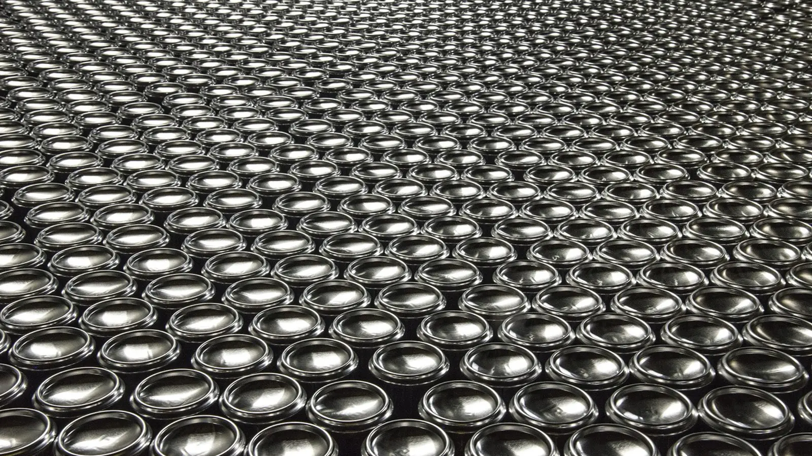 Rows of black cans arranged close together