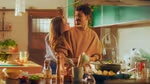 In a still from Knorr’s Green Flag social influencer marketing campaign, a woman hugs a man while he is cooking.