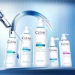 Five CLEAR scalp care products arranged in front of a curved faucet on a blue gradient background.