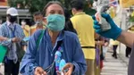 Woman wearing a mask carrying a bag
