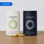 Two Nutrafol hair growth supplement containers labelled “Women” and “Men” with capsules placed on a wooden surface. The image is tagged ‘Channel’.
