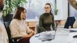Two younger women chatting in a roundtable format