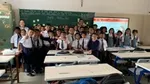 student in the class with the teacher